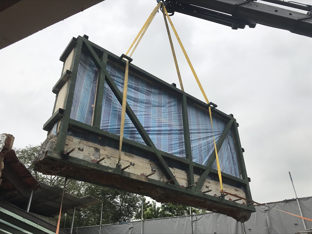 The mural wall being hoisted into the A-frame