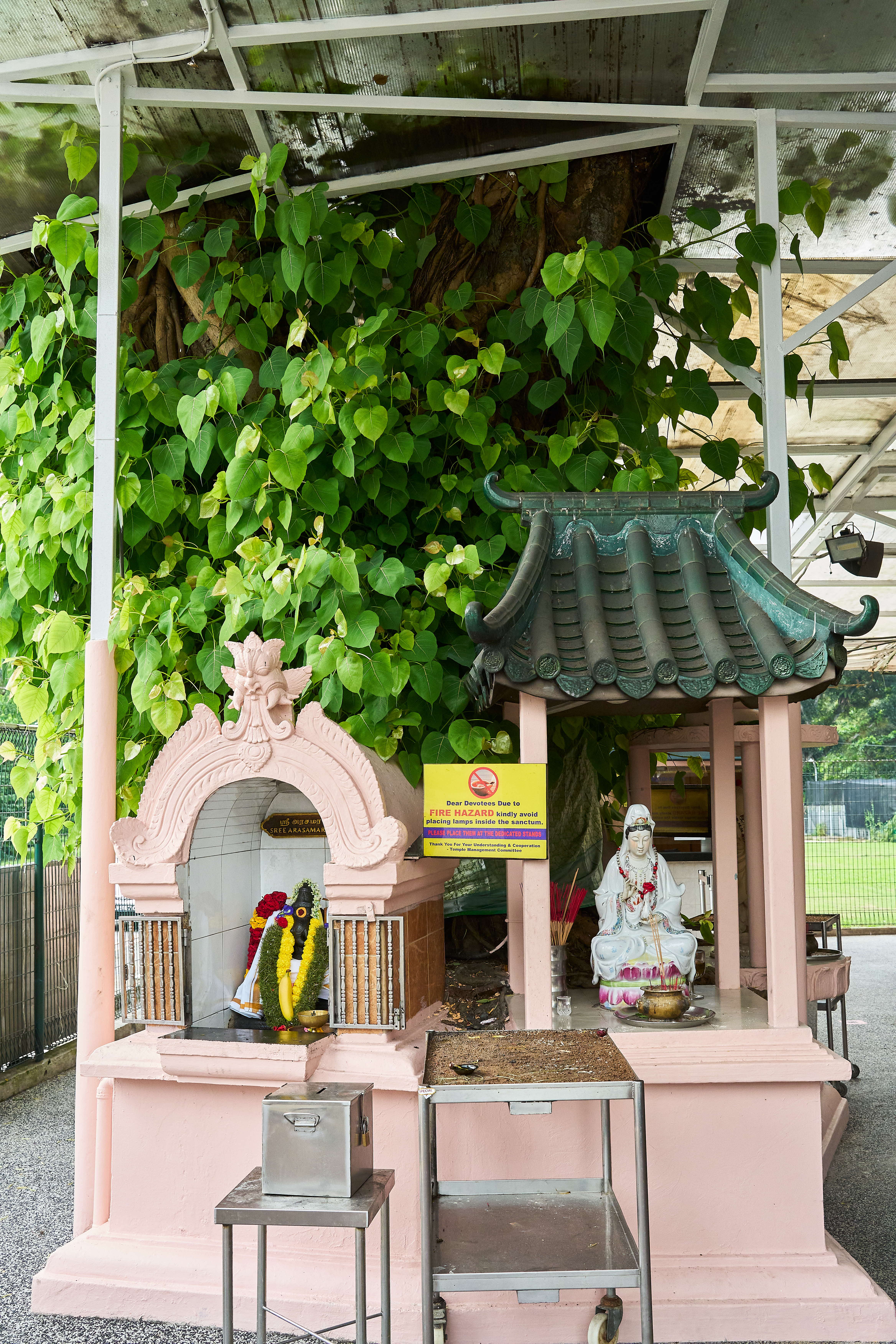 Shrines of non-Hindu deities Guan Yin and Buddha at the temple.