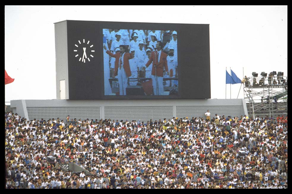 A display screen above spectators, pictured at National Day Parade 1992 held at National Stadium. (c1992. Image from Ministry of Information and the Arts Collection, courtesy of National Archives of Singapore)