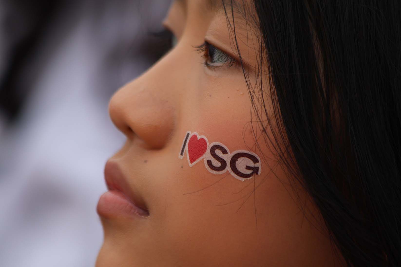 Alongside face paint, spectators these days also show up to the National Day Parade with temporary face tattoos. (c2025. Image from NDP 25)