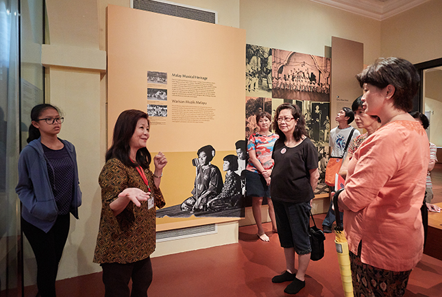 As a docent, May enjoys talking to people from all walks of life.