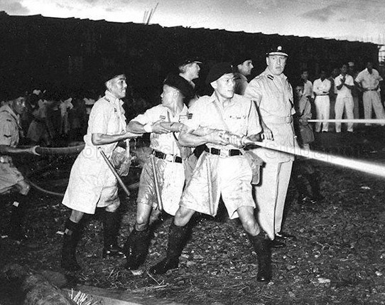 Riot Police using a high-power water jet to disperese rioters