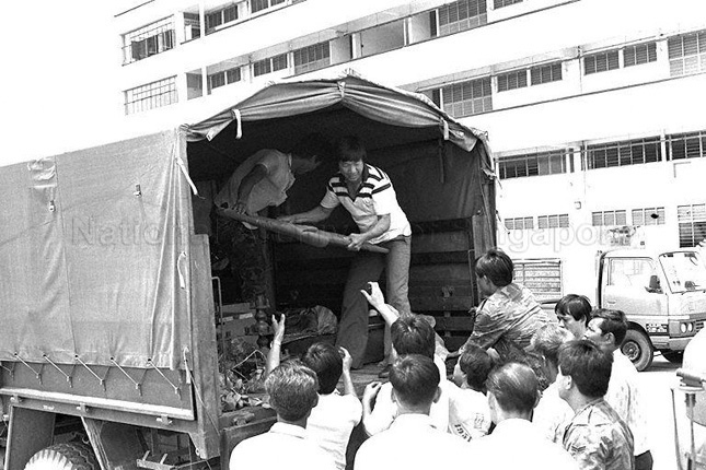Army personnel assisting residents of Pulau Tekong in relocating to mainland Singapore
