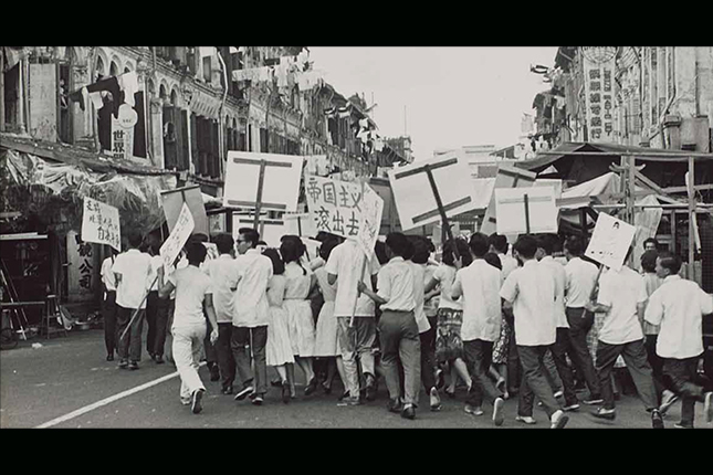 Students holding placards with anti-colonial slogans during the Singapore Chinese Middle School Student Union riots. They were protesting against the detention of four student leaders and expulsion of 142 students from Chinese High School and Chung Cheng High School for pro-communist activities. (1956).