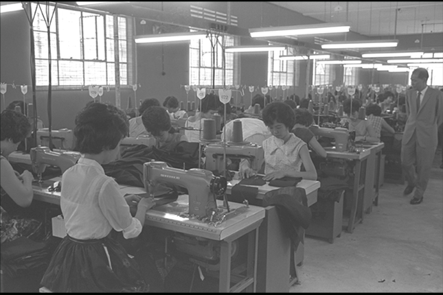 Seamstresses at work in Wing Tai Garment Factory. Textiles were one of the many sectors that Singapore invested in on the move towards industrialisation during the 1960s. (1963).