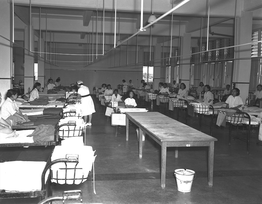 Interior of Block 2's Nightingale ward, showing the classic open-plan layout with beds positioned perpendicular to full windows, 30 May 1950. Courtesy of the National Archives of Singapore.