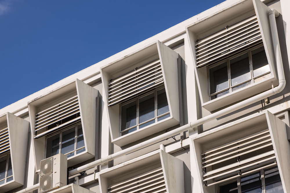Built in 1955, Block 1 features modern construction techniques with larger windows shaded by concrete fins. Photographed by Finbarr Fallon, 2025.