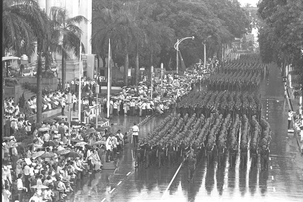 Contingents of Singapore Armed Forces marching past City Hall at the 1968 National Day Parade
