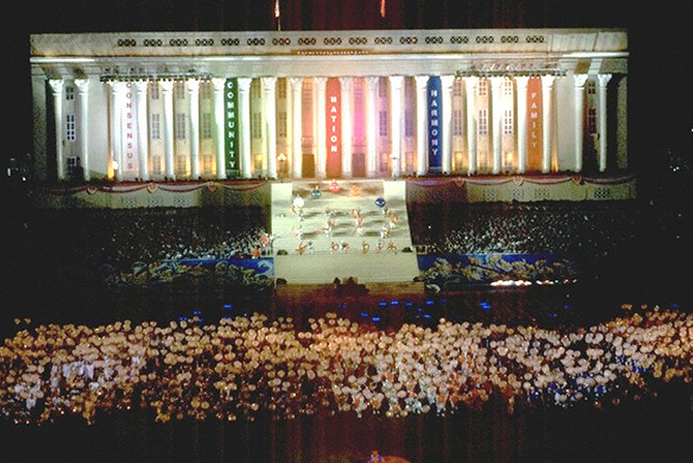 Photograph of “City Hall” adorned with banners with the words “Consensus”, “Community”, “Nation”, “Harmony” and “Family” at the 1998 National Day Parade
