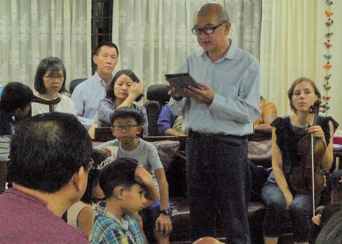 Mr Foo reads a message from the International House of Justice. Image courtesy of National Heritage Board.