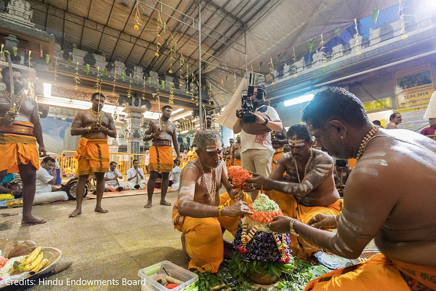 Practitioners adding layers of a variety of flowers to the Karagam. Credits: Hindu Endowments Board.