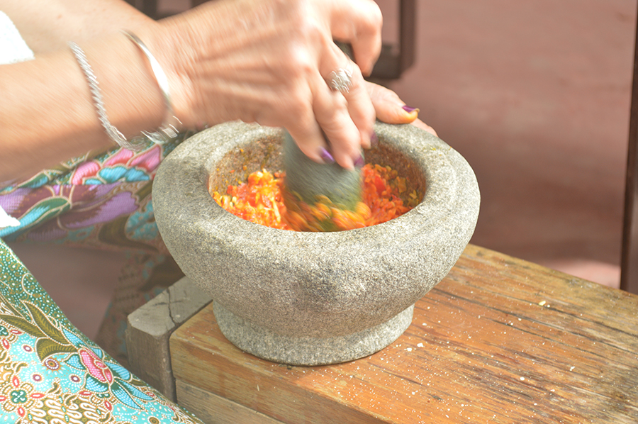 Pounding Chilli on a Mortar and Pestle.