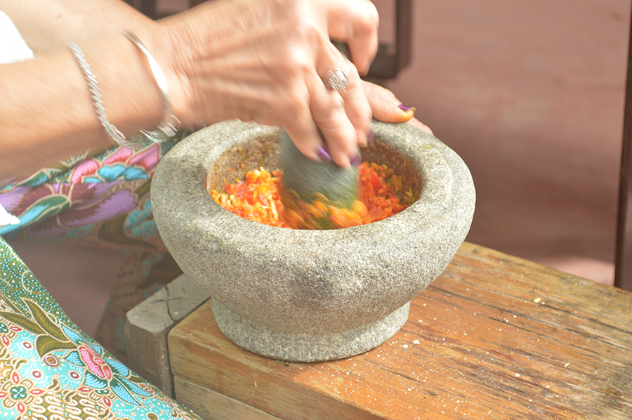 Pounding Chilli on a Mortar and Pestle.