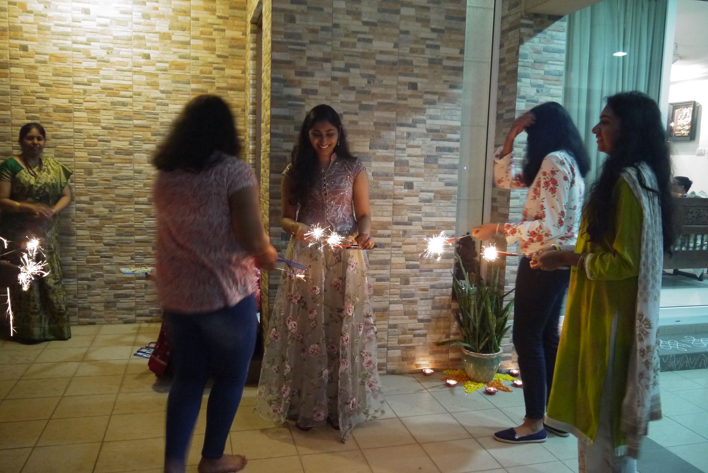 A family lighting sparklers as part of Deepavali celebrations