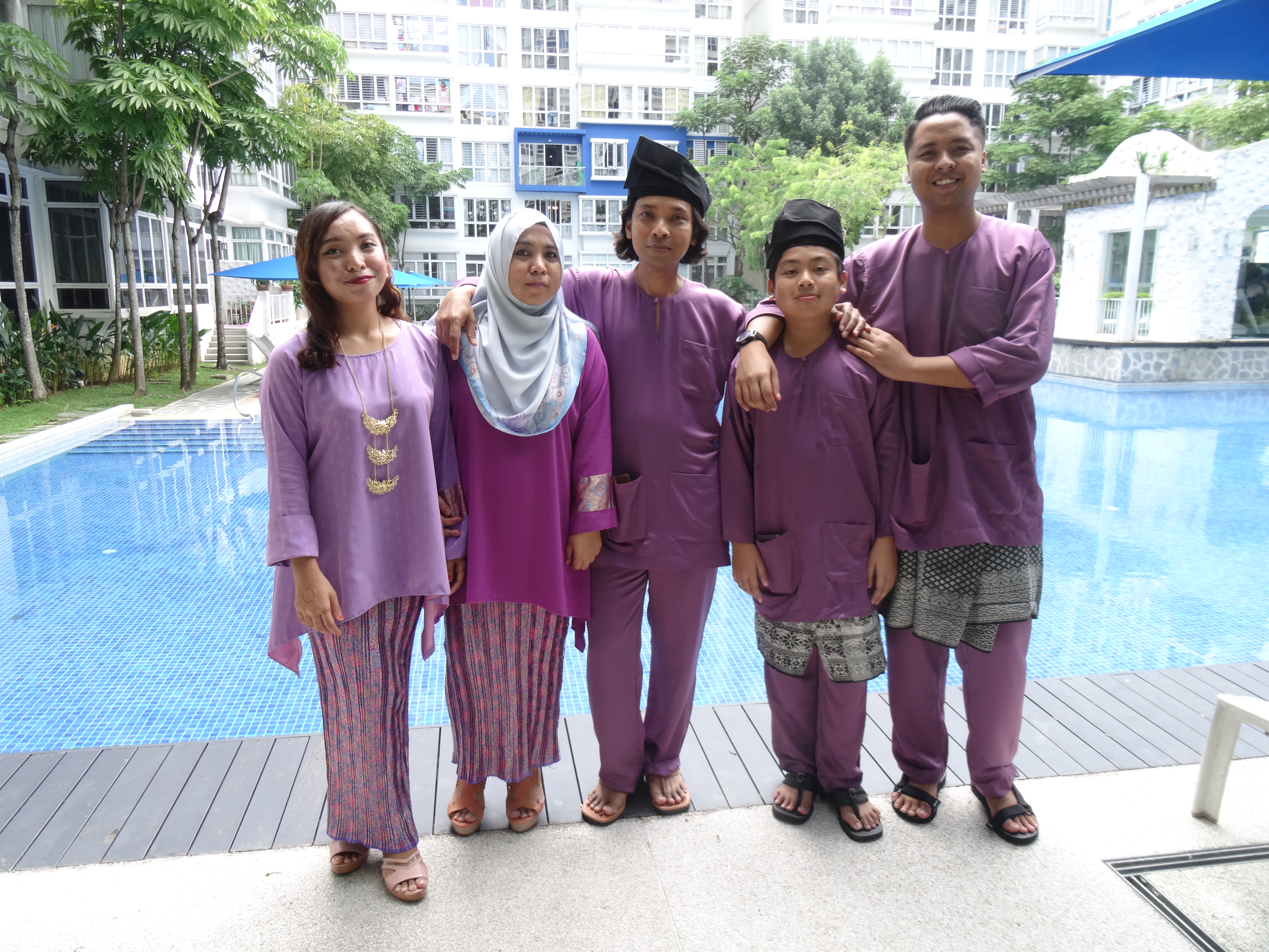Mr Ismail bin Ali (in the middle) and his family dressed in coordinated outfits for Hari Raya Puasa.