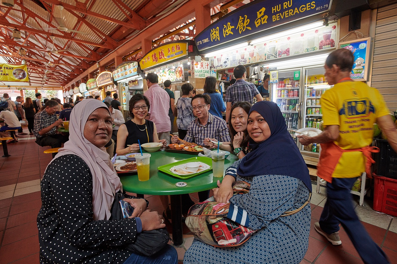 A group of colleagues having a meal at Maxwell Food Centre.