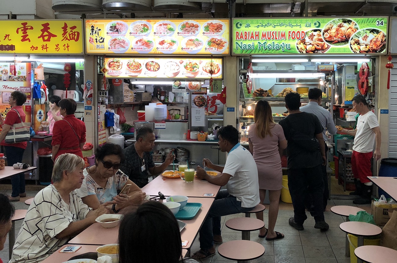 Stalls by diverse communities, including Chinese and Malay hawker stalls, co-exist side by side at a hawker centre in Whampoa.