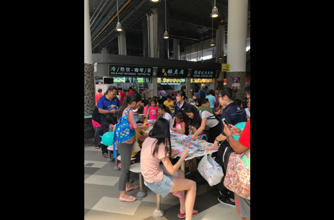Community groups having an art-jamming session at a hawker centre at Our Tampines Hub.