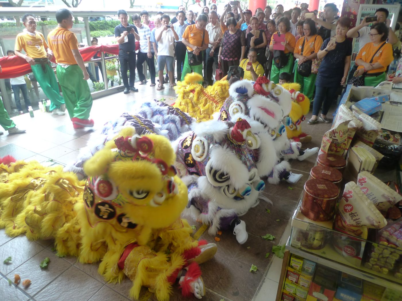 A lion dance troupe at a shopfront, to bring auspicious luck and good fortune