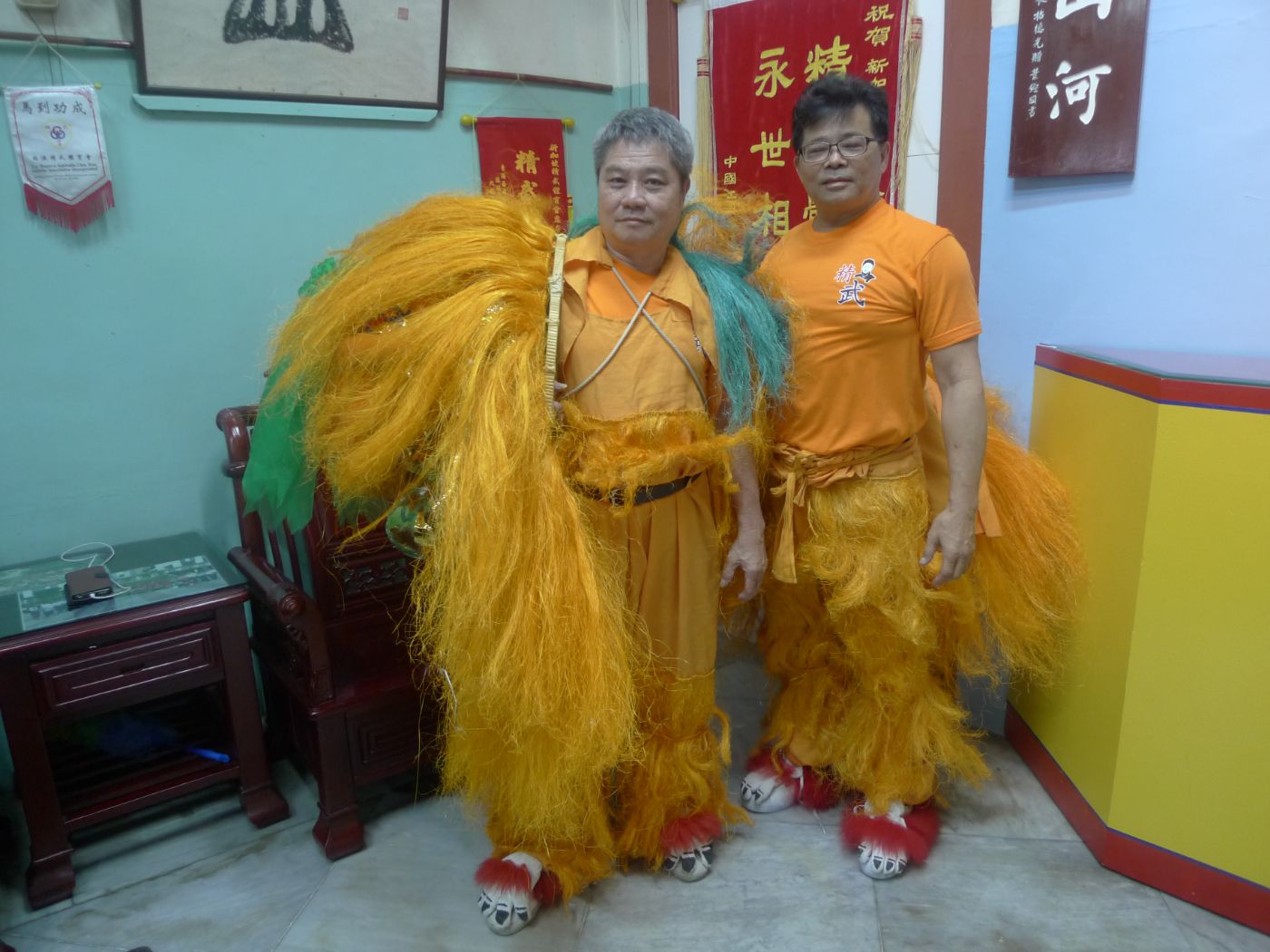 Mr Lim Soin Khoon (left) from Singapore Chin Woo Athletic Association with a troupe member in their lion dance costumes.  