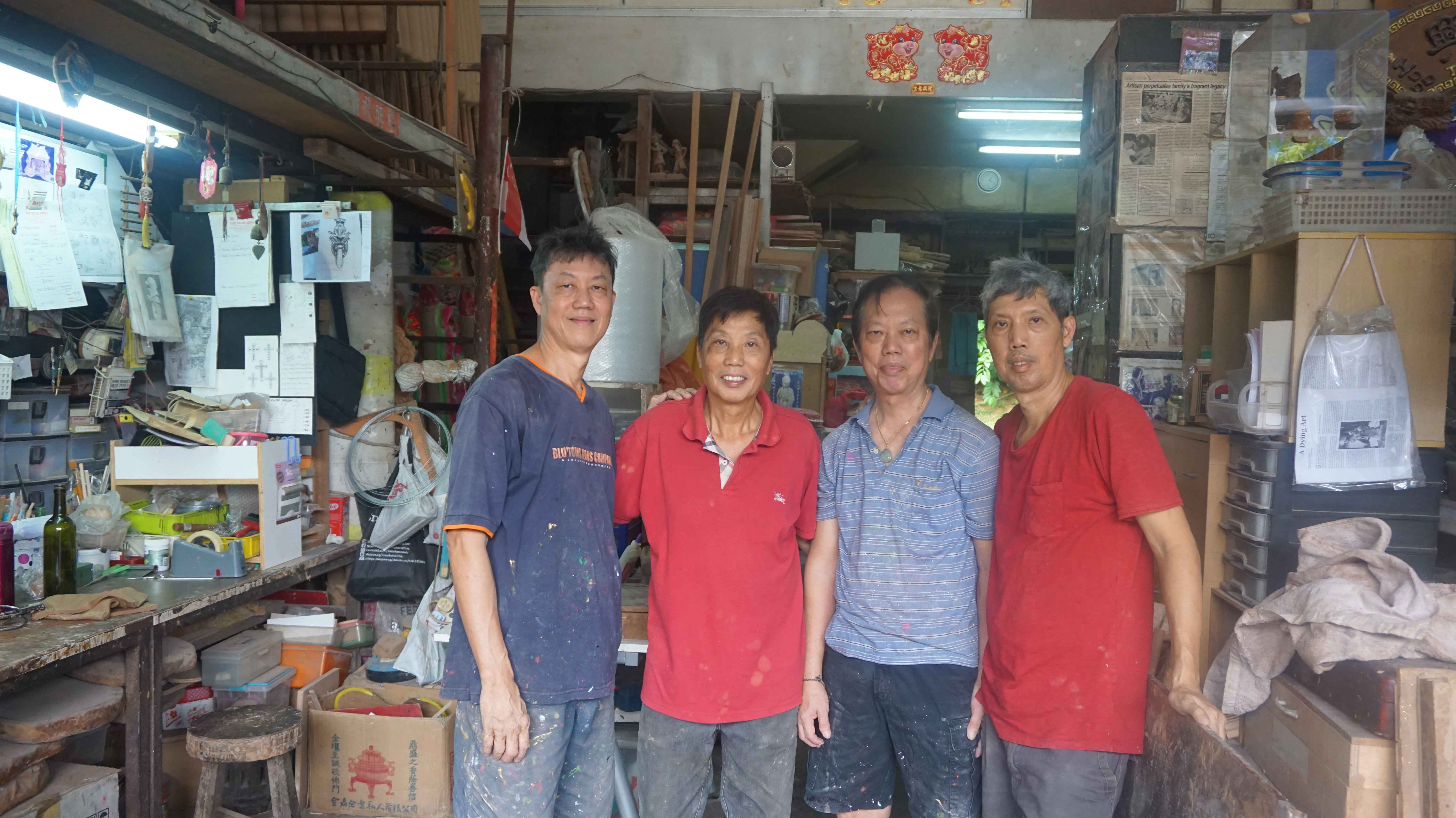 Mr Amos Tay (rightmost) with the Tay brothers, who help out at the store.