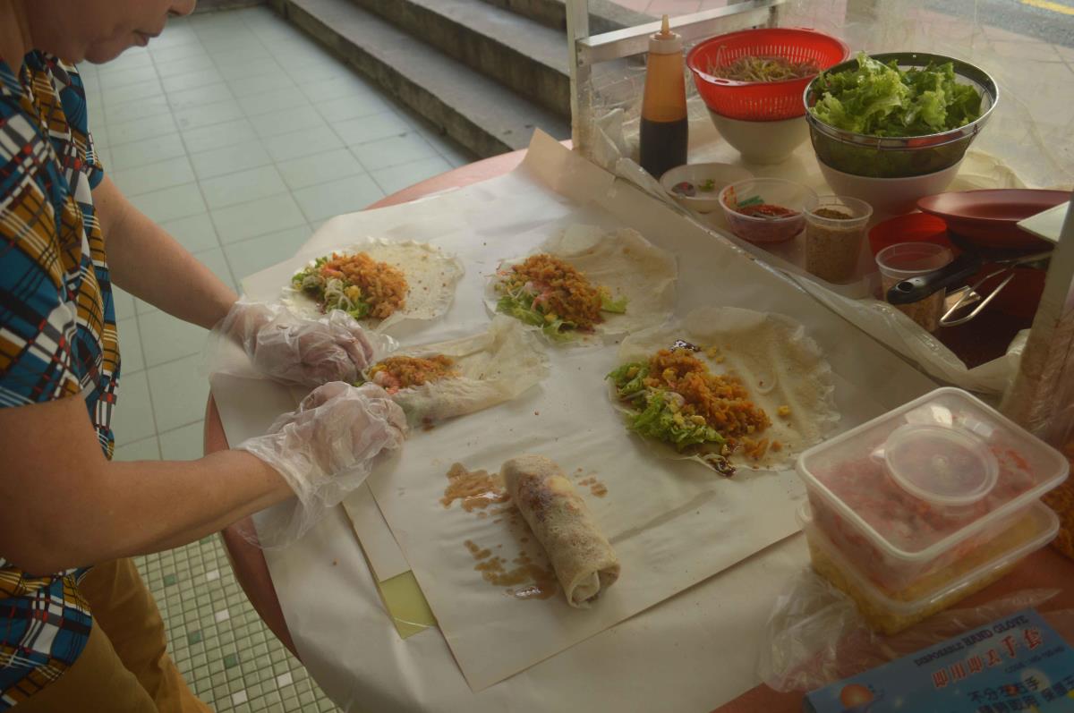 Popiah is a spring roll made from thin flour skin wrapped around finely chopped vegetables and meat.