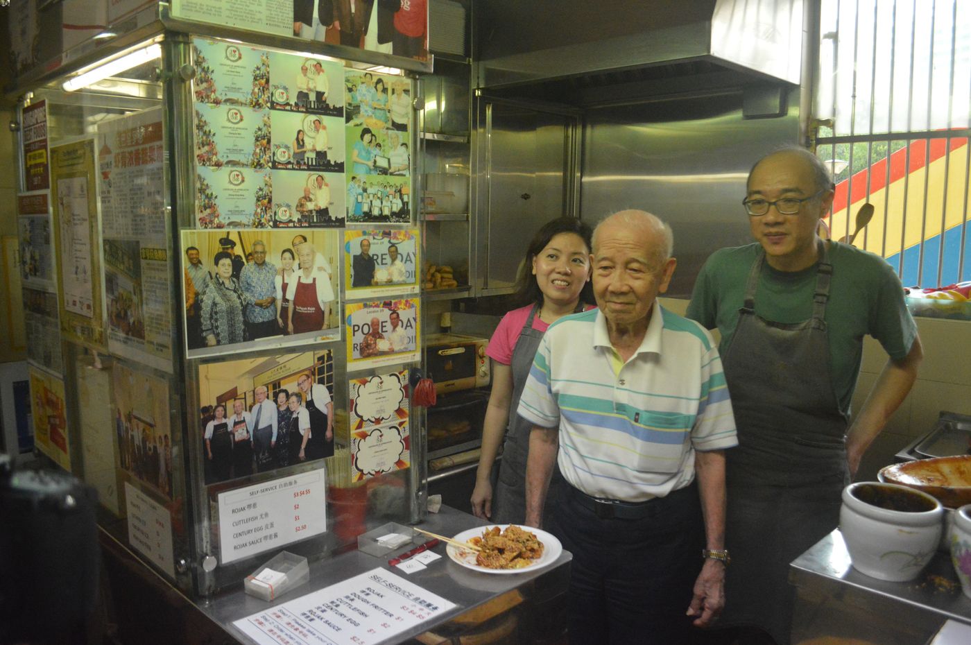 Mr Cheng Kong Sang (centre), with a plate of Chinese rojak at his stall, Toa Payoh Rojak. Behind him are his daughter, Ms Regina Cheng, and her husband, Mr Lim Swee Seng. 