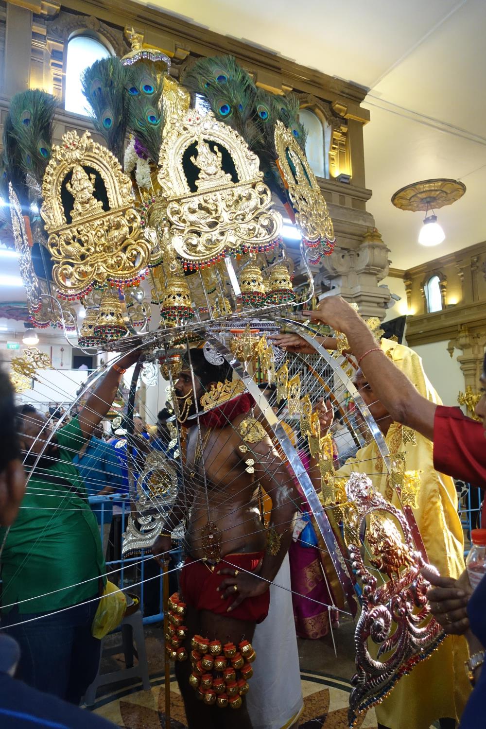 Mr Murali Raj with his fully assembled kavadi. This elaborate structure is held up by the long spikes pierced through his body.