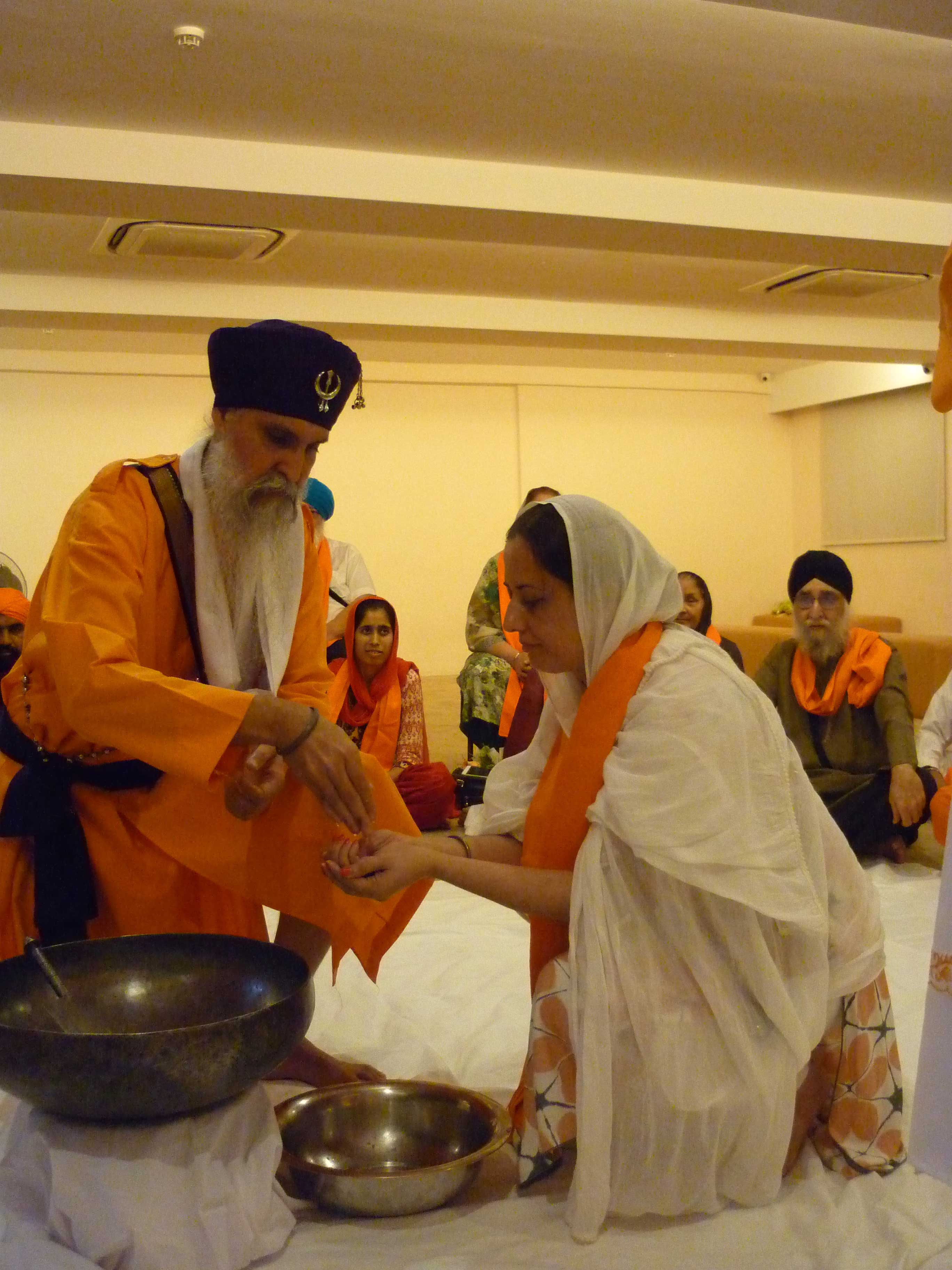 A devotee receiving the <i>amrit</i> (baptismal water) during the <i>Amrit Sanchar </i>ceremony.