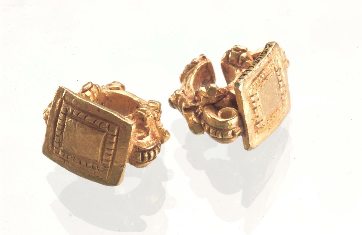 Pair of ear ornaments with rectangular incised bezel