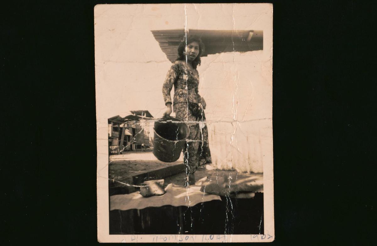 A Malay Woman Carrying Pail