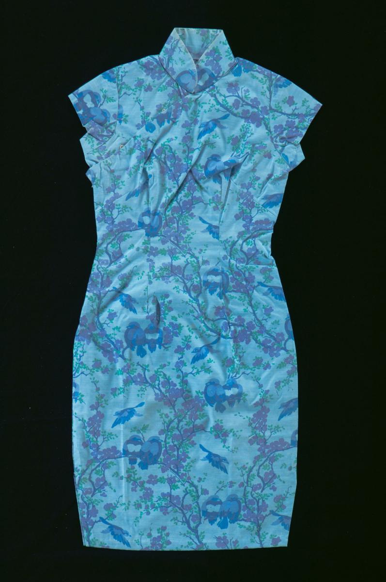 A blue cheongsam with printed birds on trees