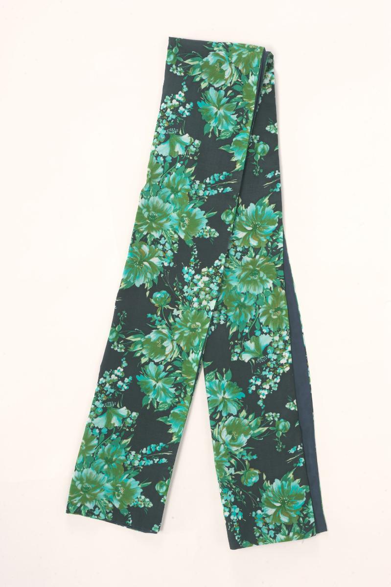 A black shawl with green floral motifs