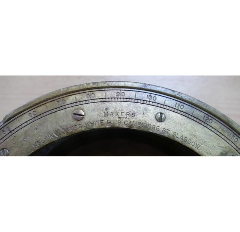 <em>Brass compass with makers&rsquo; mark.</em>