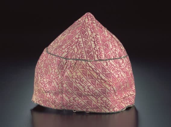 <p style="text-align: center;"><a href="https://www.roots.gov.sg/Collection-Landing/listing/1224881"><strong>Silk cap with calligraphic motif</strong></a><br> 2000-09138<br> 19<sup>th</sup> century<br> India<br> Collection of Asian Civilisations Museum