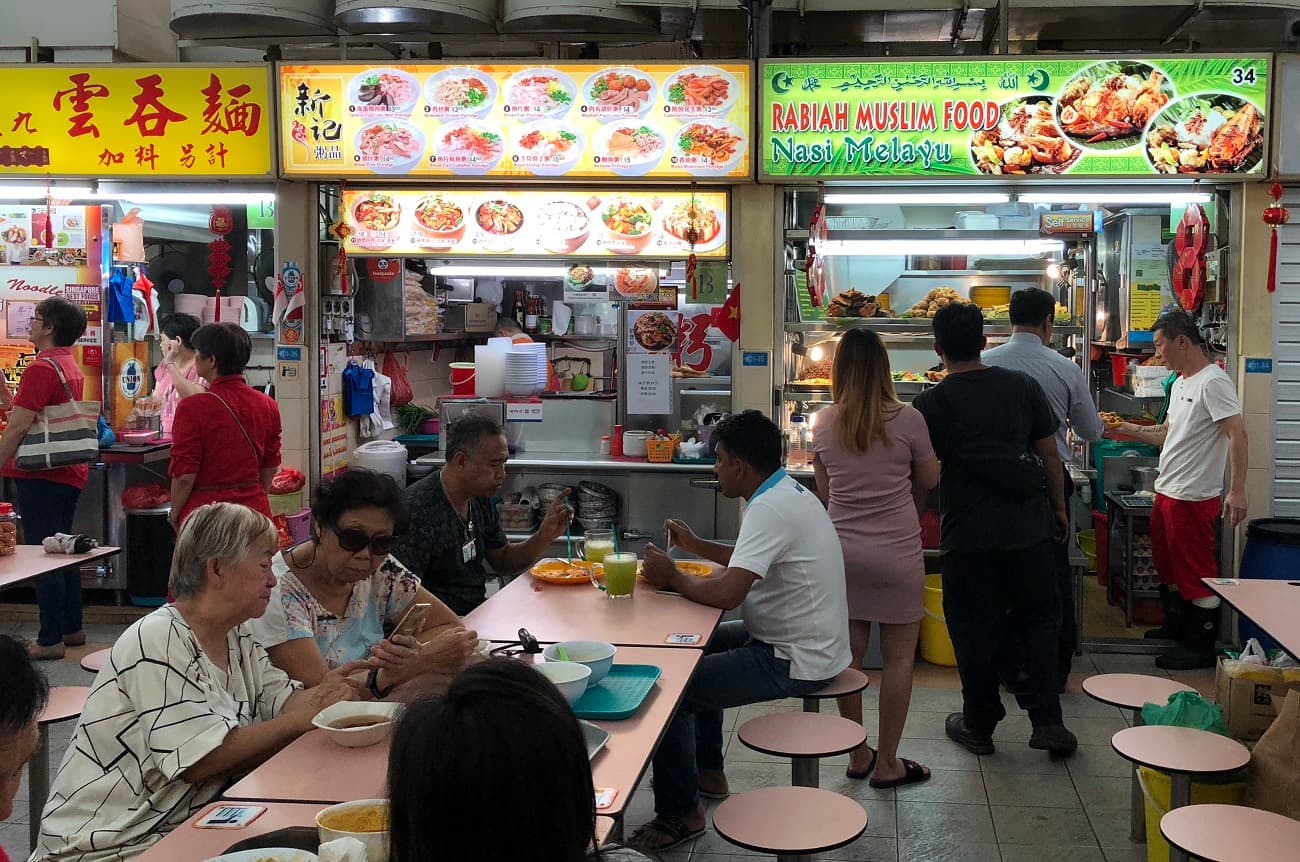Stalls by diverse communities, including Chinese and Malay hawker stalls, co-exist side by side at a hawker centre in Whampoa.