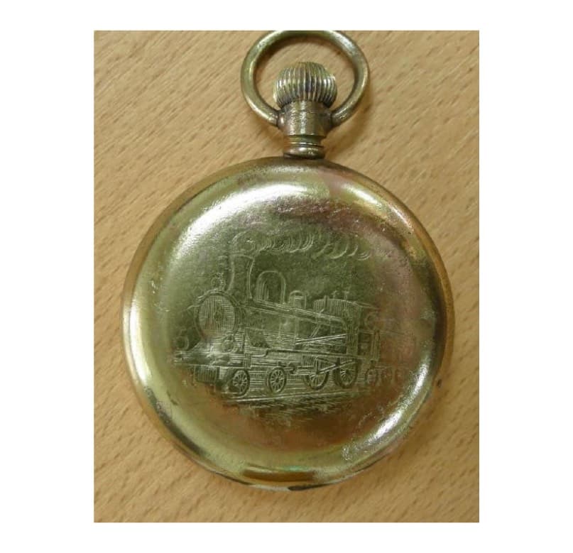 <em>Brass pocket watch &ndash; with a steam locomotive engraved on the back.</em>