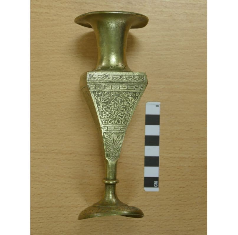 <em>An engraved brass vase – which may have been for floral arrangements or may have been purely decorative.
<p></p></em>