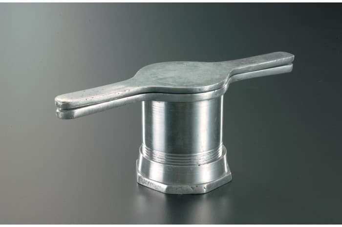 <strong><em>Murukku nazhi</em> (kitchen press for making <em>murukku</em>)</strong><br>
1991<br>
Stainless steel<br>
Collection of the National Museum of Singapore