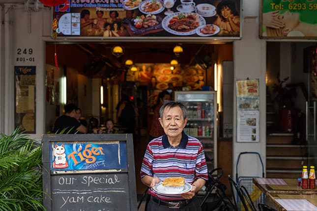 Owner at Entrance of Prince Coffee House