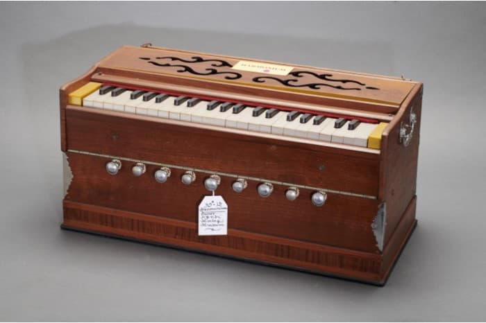 <strong>Harmonium (hand-pumped)</strong><br>
A keyboard instrument where sounds are created by air pumped over a set of free-floating reeds (brass strips).