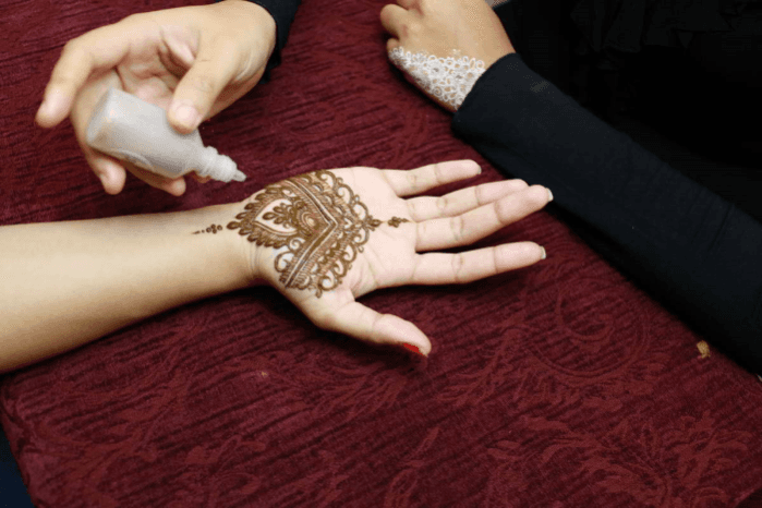 Adding glitter to the design.