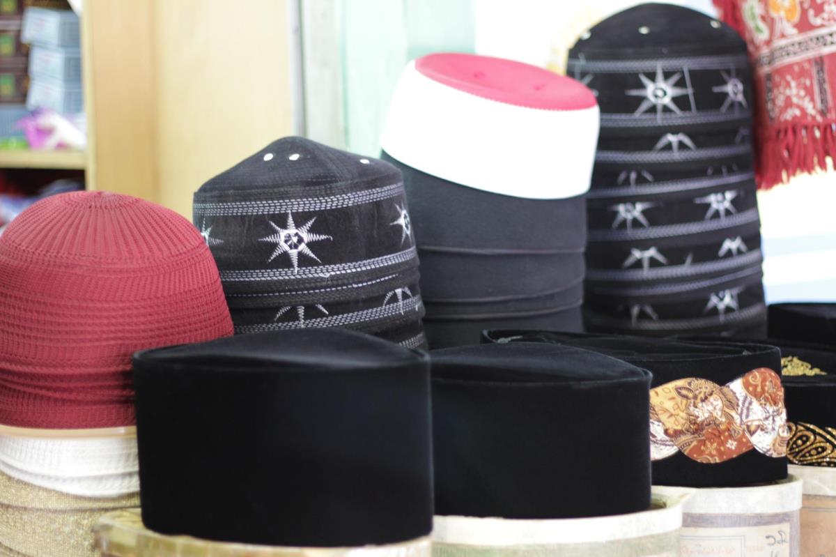 Versions of songkoks lining the front of a stall at Kampong Glam.