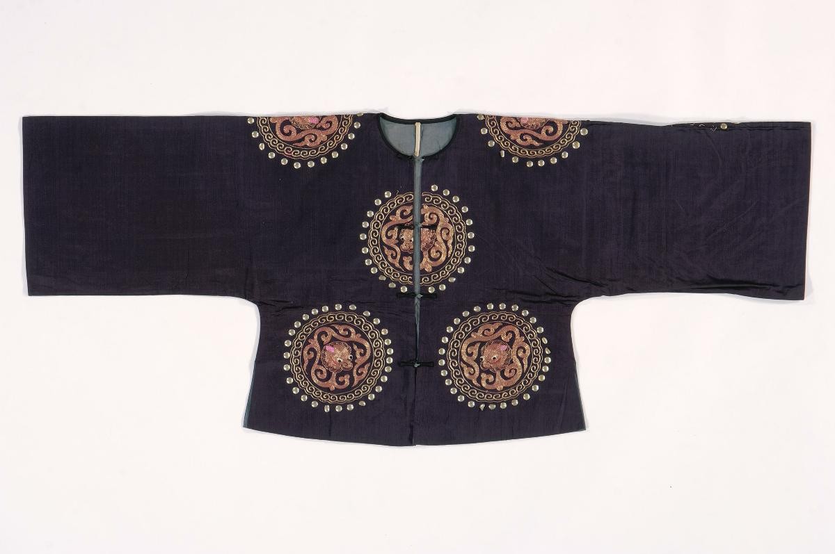 A purple top with embroidered gold dragon motifs worn by a ‘wu sheng’ in a Chinese opera