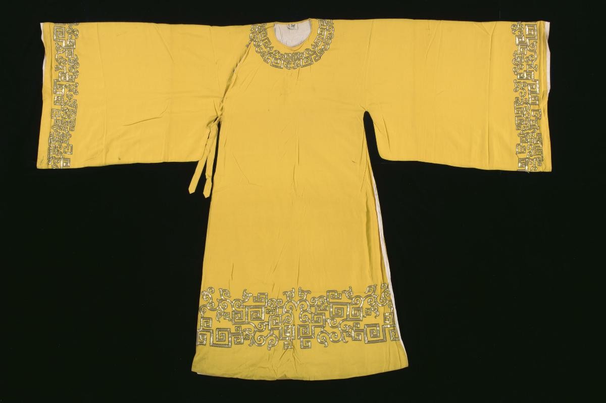 A yellow robe with gold embroidery worn by an emperor in a Chinese opera