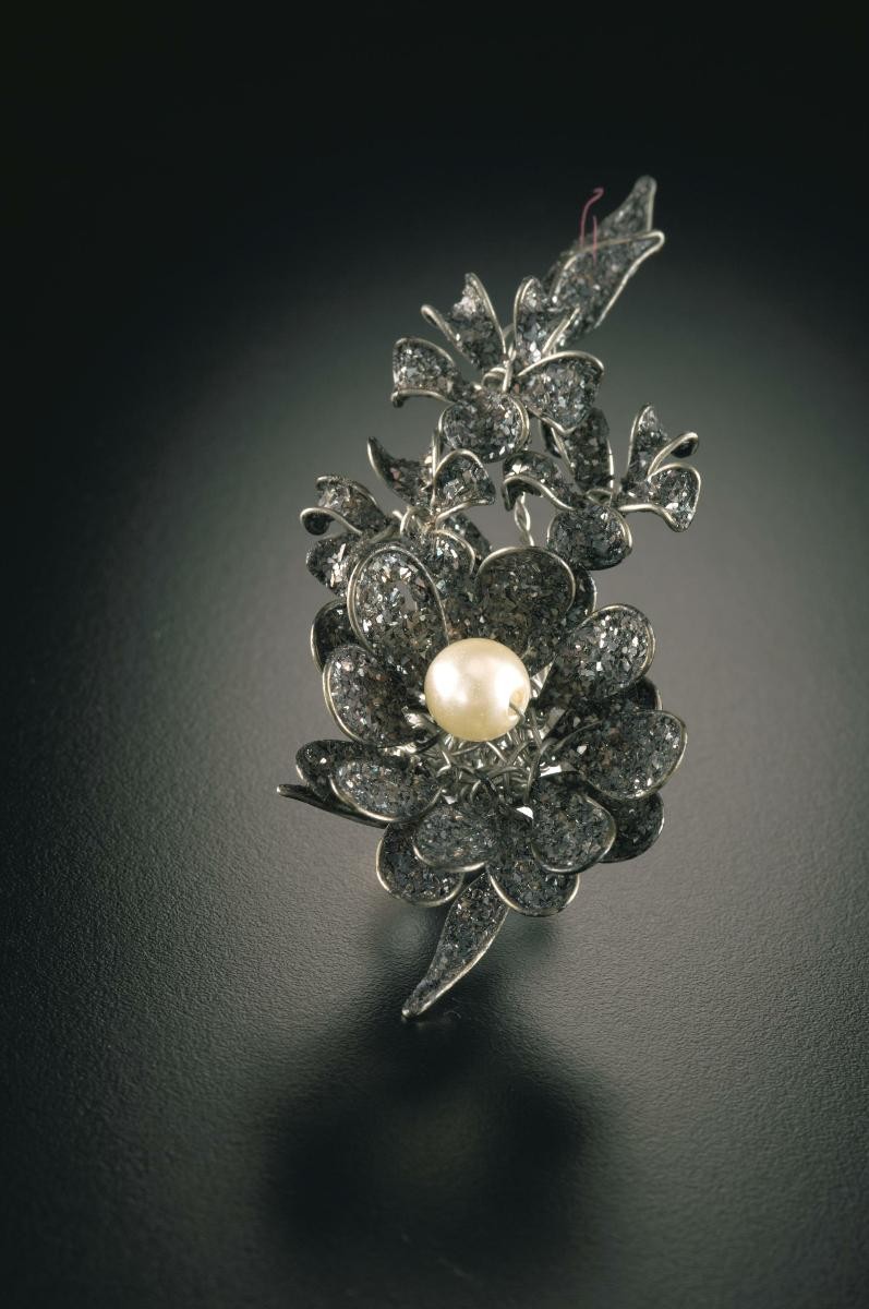 A pair of ear rings adorned with pearl and crystal that belonged to a notable women's rights activist