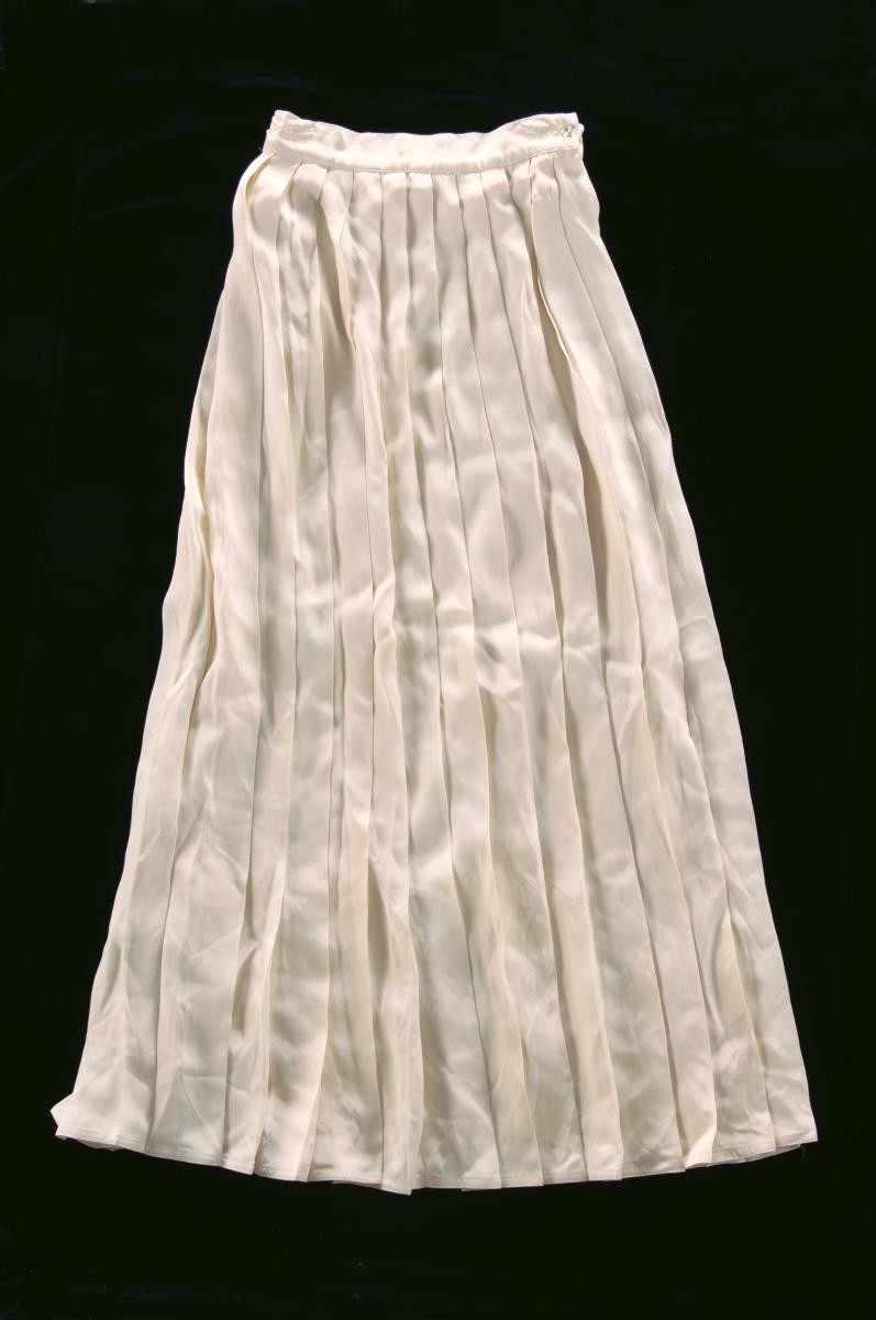 A pleated ivory skirt by Benny Ong