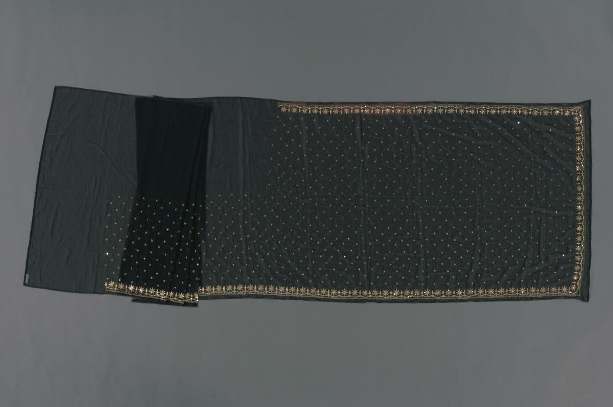 A black sari with gold sequins