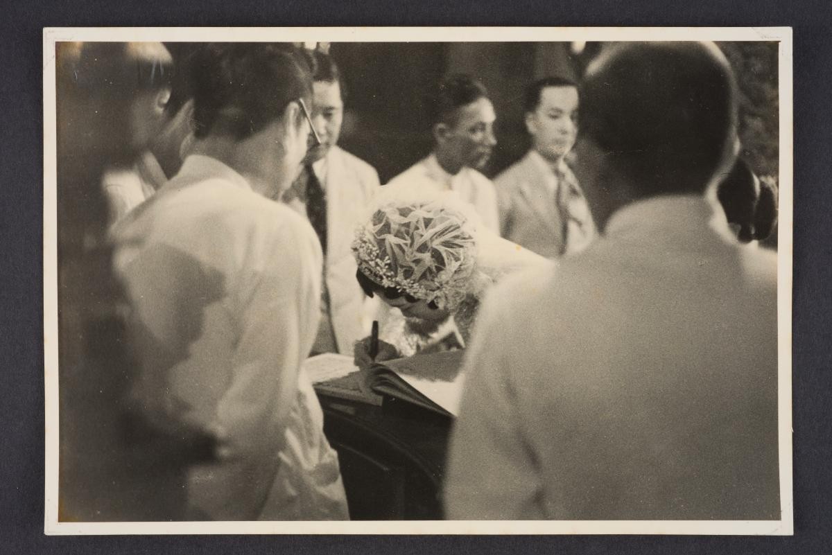 On back: "The bride signing the register"