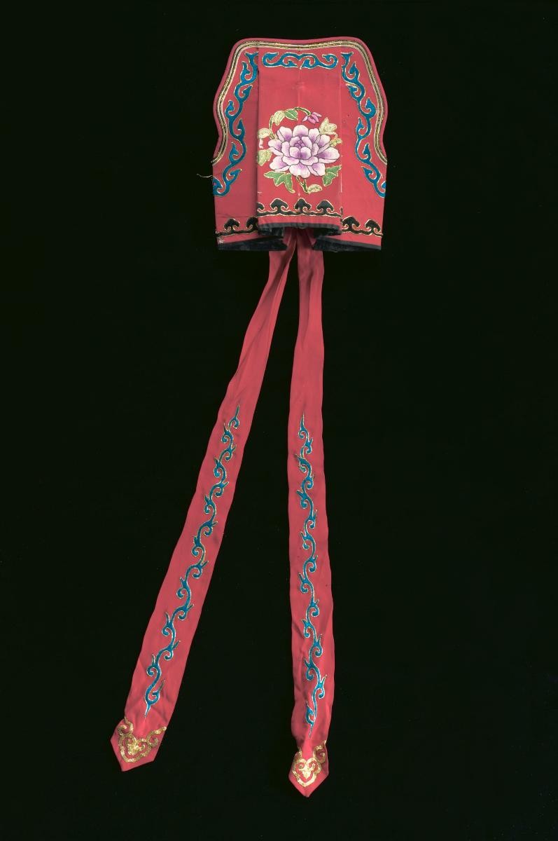 A red hat with pink floral motifs worn by a ‘wen xiao sheng’ in a Chinese opera